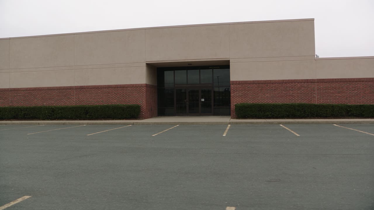 The entrance of a low commercial office park on an overcast morning