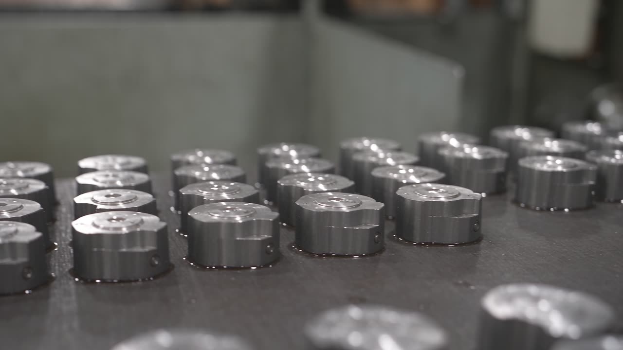 Machined metal parts moving along a production line conveyor
